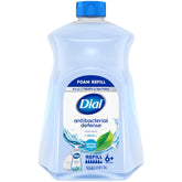 Dial Antibacterial Defense foaming soap bottle with aloe beside kitchen sink for hygiene.