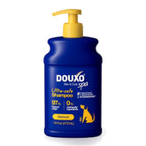 Douxo Skin & Coat Spa Oatmeal Shampoo bottle poured for gentle cleansing.