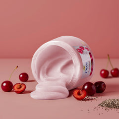 Crushed cherries visible in Dove scrub for revitalizing feel and aroma