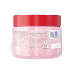 Dove exfoliating scrub in hand applying creamy texture to skin.
