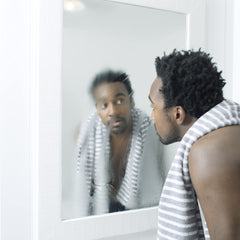 Dove Men+Care Hydrate Face Wash lather in hand highlights creamy cleansing for dry skin comfort.