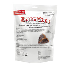 Dog enjoying a DreamBone Grill Masters T-Bone chew in a backyard.