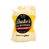 Duke’s Real Mayonnaise pouch pours smoothly, highlighting its creamy texture for sandwiches.