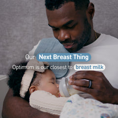 Combo feeding setup with Enfamil Optimum beside a breast milk bottle.