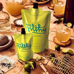 Filthy Food margarita mix being poured into a glass for a refreshing margarita