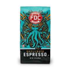 Fire Department Coffee Shellback Espresso beans on table, bold aroma for morning wake-up.