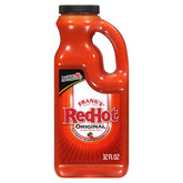 Frank's RedHot Original hot sauce bottle pouring over crispy wings for bold heat