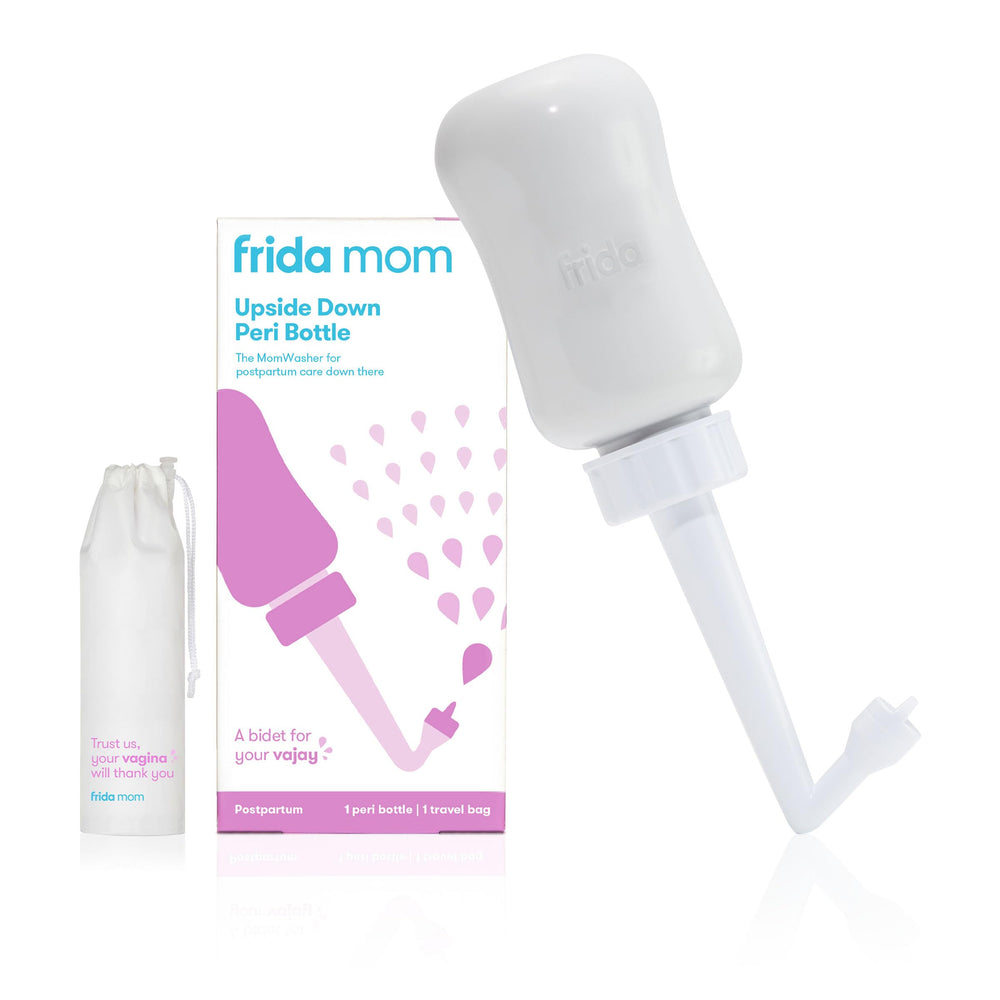 Frida Mom Upside-Down Peri Bottle angled use for gentle postpartum cleansing.