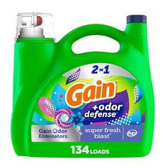 Gain Odor Defense bottle pouring for long-lasting freshness in laundry.