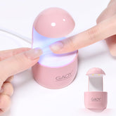 GAOY Mini UV Light in pink casing for quick gel nail curing at home.
