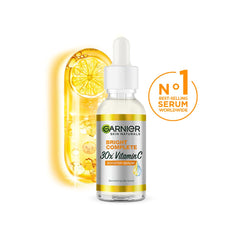Garnier Bright Complete serum dropper applied to cheek for even tone
