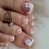 GCSQW French Tip press-on toenails with white flower for chic summer style.