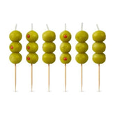 Genuine Fred cocktail olive candle on a wooden pick adds playful cake garnish