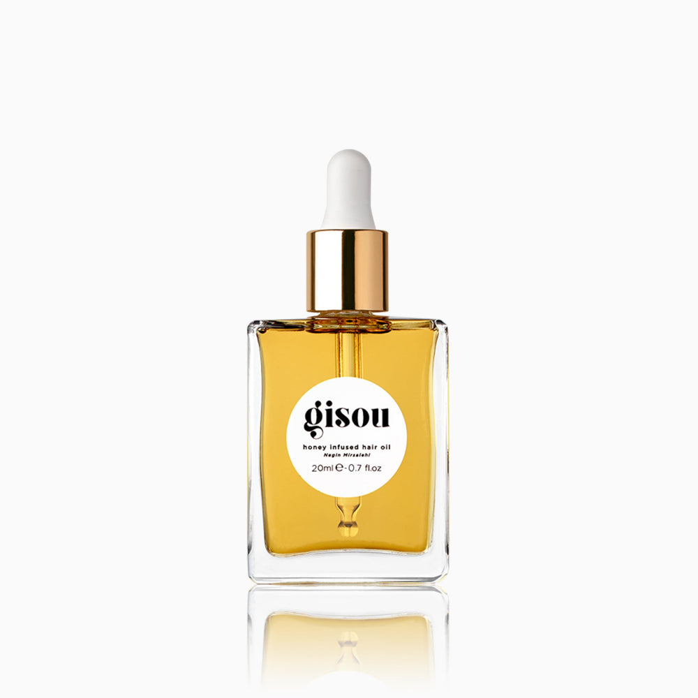 Gisou Honey Infused Hair Oil mini bottle prepared for travel and shine
