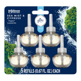 Glade PlugIns Sea Mist & Cypress bottle releasing long-lasting fragrance in the living room.