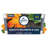 Glade Smooth Bourbon & Oak jar candle with inviting amber glow for relaxing ambience.