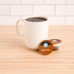 Compostable Happy Belly coffee pods ready for a sustainable morning brew.
