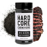 Hardcore Carnivore Black bottle front view for bold charcoal seasoning on steaks.