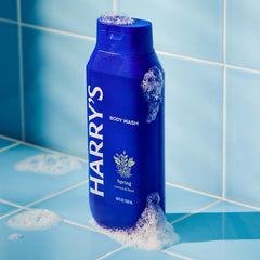 Harry's Spring body wash bottle closeup emphasizes skin hydration and softening.