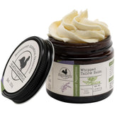 Hearth and Homestead lavender peppermint balm bottle on wood, provides daily moisture.
