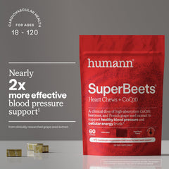Pouring Humann SuperBeets Heart Chews from the bottle for on-the-go use.