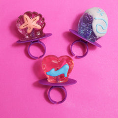 Bulk candy lollipop rings with assorted flavors: watermelon, grape, strawberry.