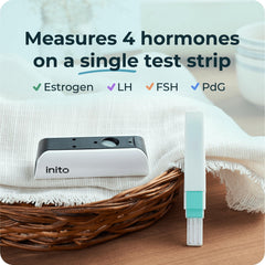 Inito test strip being dipped for a quick 15-second urine test