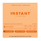 Instant Hydration orange packets poured into a glass for refreshing hydration.