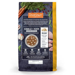 Instinct Raw Boost freeze-dried chicken pieces sprinkled among kibble pieces.