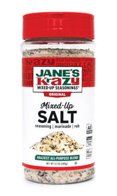 Jane's Krazy Mixed Up Salt canister on a kitchen shelf for easy seasoning.