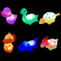 Colorful plastic egg showcases glowing dinosaur bath toy in hand.