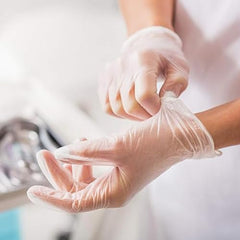 Jointown Basic vinyl gloves on hand with ambidextrous fit for versatile tasks.