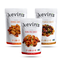 Kevin's Natural Foods orange chicken simmer sauce bottle pour highlights bold flavor for quick weeknight dinners.