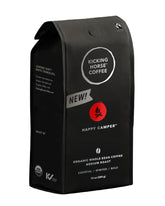 Kicking Horse Happy Camper coffee bag showcasing organic and fairtrade quality for eco-conscious brewers.