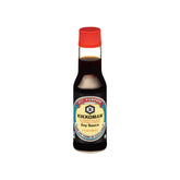 Kikkoman Naturally Brewed Soy Sauce bottle pouring into a dish for savory marinades.