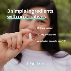 Klaralyte capsules in hand illustrate easy on-the-go hydration.