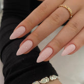 KQueenest dusty pink almond press-on nails shown in application close-up for quick at-home manicures.