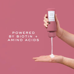Kristin Ess Biotin Deep Conditioner being applied to hair during routine