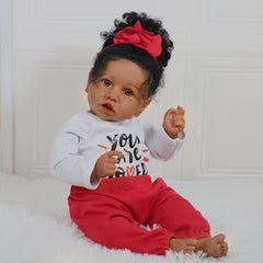 KSBD Realistic 20-inch doll posed sitting for easy display.