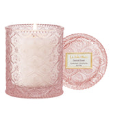 LA JOLIE MUSE Santal Rose candle jar with daisy embossing enhances decor and ambiance.