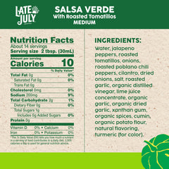 Late July Salsa Verde jar on counter with chips for dipping.