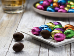 The Madelaine Chocolate Company jewel-tone foil eggs with smooth dark chocolate.