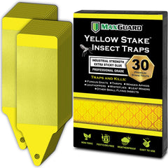Maxguard yellow stake sticky trap placed in a garden to capture flying insects.