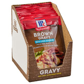 McCormick 30% Less Sodium Brown Gravy Mix packet ready to simmer for rich flavor.