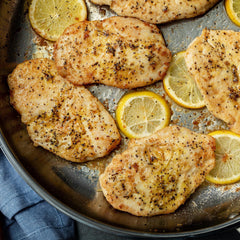 Closeup of McCormick Perfect Pinch Lemon Pepper on seafood ready for grilling.