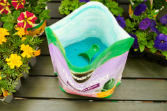 Miracle-Gro Bloom Booster poured into a watering can for quick garden feeding