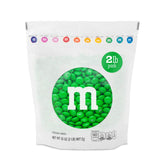 M&M'S WORLD green milk chocolate candy bag front, ideal for bulk party snacks.