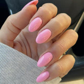 Modelones short press-on nails in pink with oval shape for quick at-home manicure.