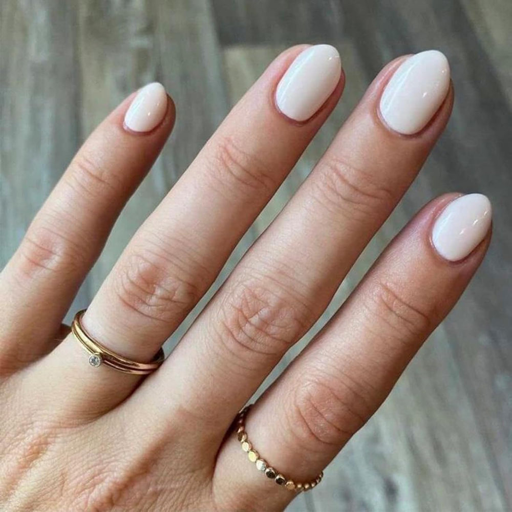 Modelones short press-on nails in oval white kit for quick, stylish manicure.