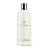 Molton Brown Purifying Conditioner bottle ready to detangle and soften hair